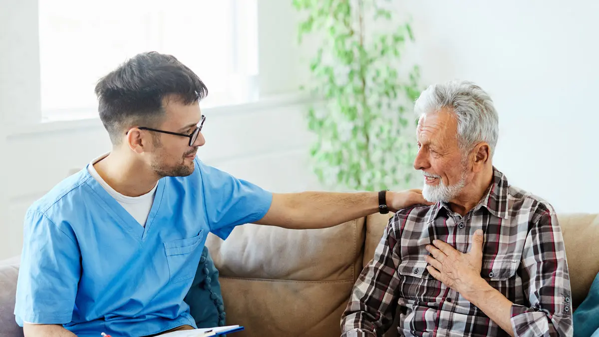 senior man with occupational therapist on couch